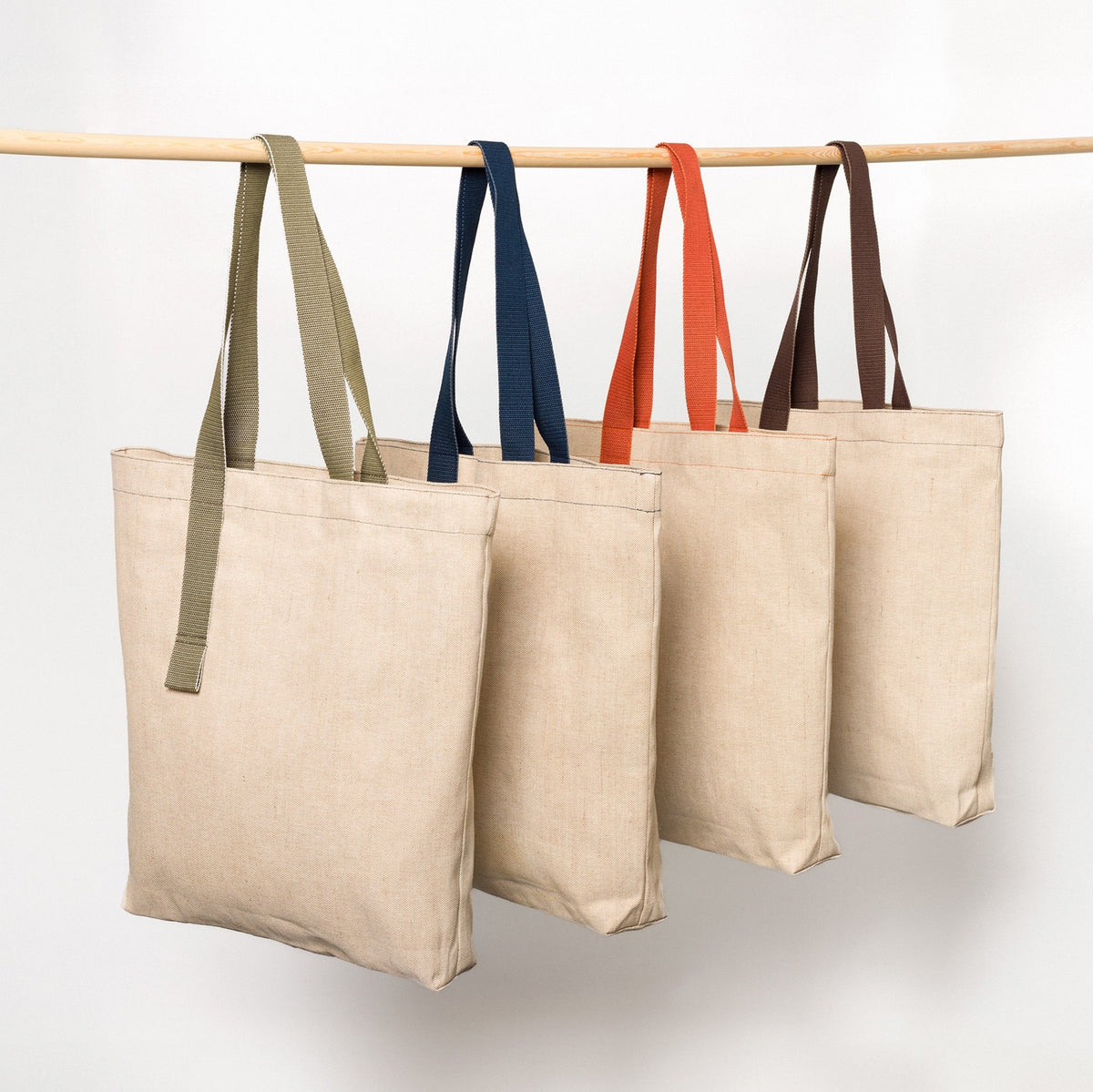 
                  
                    Shangies jute bags with handles in different colours hanging side by side
                  
                