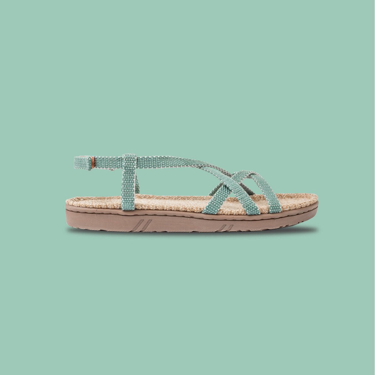Side view of a Shangies kids sandal in Minty Mint against a mint-green background